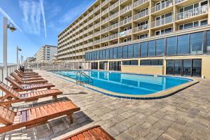 a swimming pool in front of a building at Daytona Beach Retreat Beach Access! in Daytona Beach