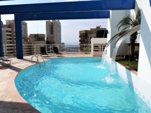a swimming pool on the roof of a building at Mondrian Suite Hotel in São José dos Campos
