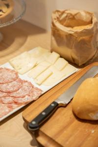 a cutting board with cheese and a bag of meat at Casa Vettor in Valdobbiadene
