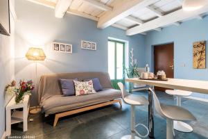 a living room with a couch and a table at San Francesco Guest House in Savigliano