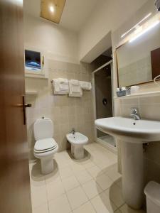 a bathroom with a toilet and a sink at Elle Palace Simply Elegant in Verona