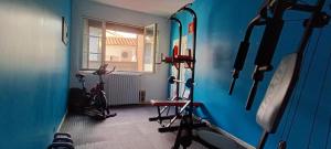 a room with several exercise equipment in a room with a window at Studio atypique Immeuble de 1820 in Fumel