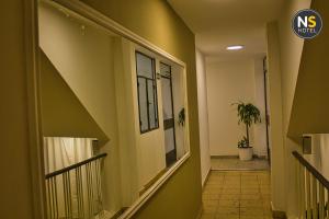 a hallway of a building with a stairway at Ns Hotel in Termas de Río Hondo