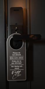 a door with a sign on it with a handle at Victoria by Petit Chic in Mellieħa