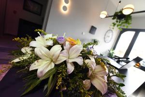 a bouquet of white flowers sitting on a table at Victoria by Petit Chic in Mellieħa