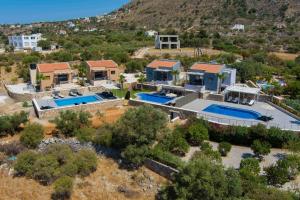an aerial view of a house with two swimming pools at Electra Villas in Kókkinon Khoríon
