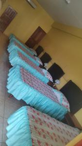 a group of five pillows lined up in a room at Hotel La Guaria in Liberia