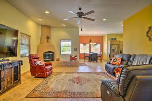 a living room with a couch and a ceiling fan at Rustic Las Cruces Escape - 2 Mi to NMSU! in Las Cruces