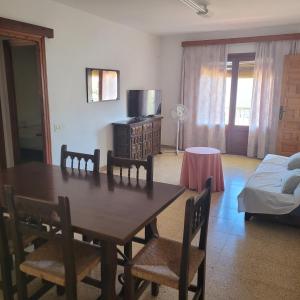 a dining room with a table and chairs and a bed at Apartamento centro de peñíscola CASA KIKO in Peniscola