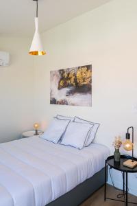 a white bedroom with a white bed with pillows at Lusíadas 53 5ºE - Beautiful River View in Lisbon