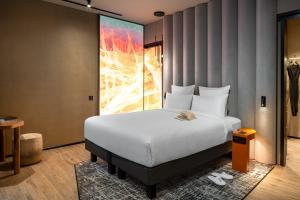 A bed or beds in a room at The Emporium Hotel Plovdiv - MGallery Collection