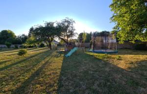 a playground with a slide in the grass at Maison de maître à 2 pas du lac des Settons in Montsauche