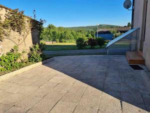 a patio with a bench next to a building at Maison de maître à 2 pas du lac des Settons in Montsauche +8 photos