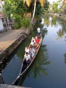 a group of people on a raft in a river at VALENTINE'S RICE BOWL HOME STAY in Alleppey