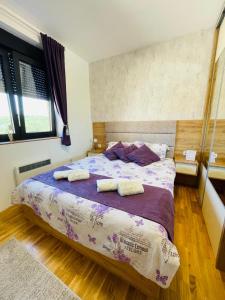 een slaapkamer met een bed met 2 kussens erop bij Lux Apartmani Vojinović in Zlatibor