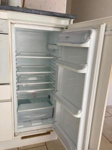 an empty refrigerator with its door open in a kitchen at Hammo in Ham