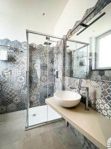 a bathroom with a sink and a shower at MARINO WELLNESS in Alì Terme