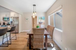 a kitchen and dining room with a table and chairs at Hideaway Unit A in San Clemente