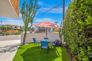 a patio with a table and chairs and an umbrella at Hideaway Unit A in San Clemente