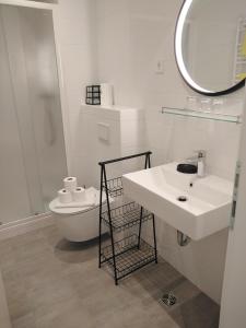 uma casa de banho branca com um lavatório e um WC em Hotel Villa Elisabeth - Veli Lošinj Health Resort em Veli Lošinj