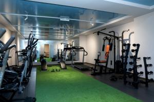 a gym with tread machines and green carpet at Best Western Plus Paradise Hotel Dilijan in Dilijan