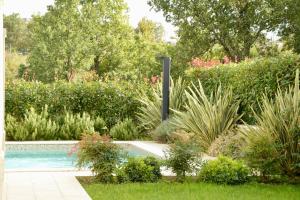 a swimming pool in a garden with plants at Private Villa "San Servolo House" with sea view and private pool in Buje