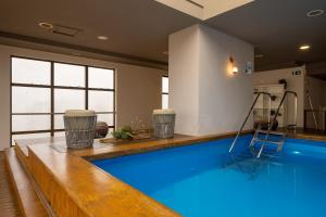 a swimming pool with a ladder in a room at Intercity Caxias do Sul in Caxias do Sul
