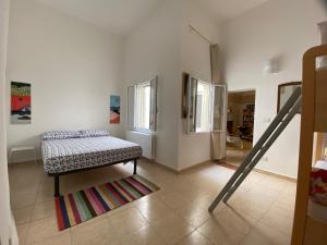 a room with a bed and a rug on the floor at La Casa al Mare in Monopoli