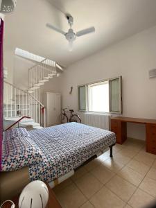 a bedroom with a bed and a staircase at La Casa al Mare in Monopoli
