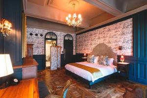 a bedroom with a large bed and a brick wall at Bayard Bellecour in Lyon