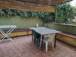 a patio with a table and two chairs on a brick floor at Casa Isa al mare in Santa Lucia