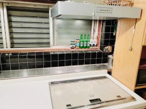 a kitchen with a stove top oven in a kitchen at Sara in Kagoshima