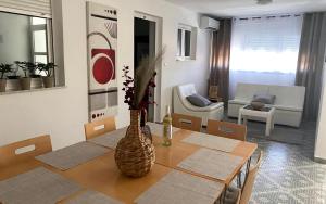 a living room with a table with a vase on it at Apartments Villa Bubi in Pula