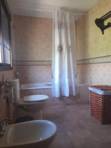 a bathroom with a tub and a toilet and a sink at El olivar de Concha, Caminito del Rey in Alora