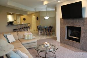 a living room with a couch and a fireplace at Lake Ozarks Get Away Topsider in Lake Ozark
