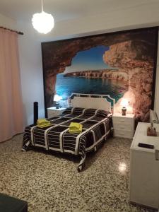 La Vilella BaixaにあるCal Tomのベッドルーム1室(壁に絵画が描かれたベッド1台付)