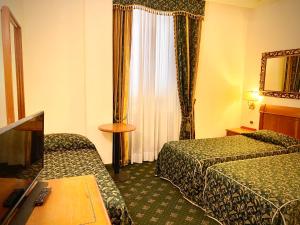 Postel nebo postele na pokoji v ubytování Hotel Champagne Palace