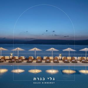 a rendering of a beach with chairs and umbrellas at Galei Kinneret Hotel in Tiberias