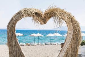 a heart made out of straw on a beach at İmaj Beach Hotel in İzmir