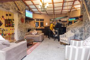 a lobby with couches and a bar with people in it at Casa Andina Standard Colca in Chivay