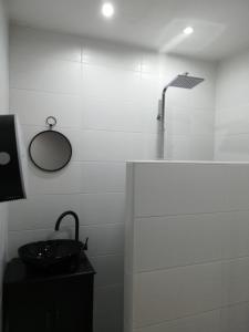 a white bathroom with a sink and a shower at STUDIO A 2 MN DE L A75 in Usclas-lʼHérault