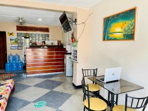 a room with a table with a laptop on it at Alojamiento Tahuari - Iquitos- Perú in Iquitos