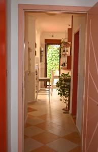 a hallway leading into a kitchen with a plant at Villa Magicland in Sofia