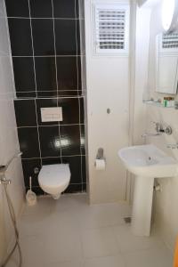 a bathroom with a toilet and a sink at İmaj Beach Hotel in İzmir