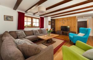 un soggiorno con divano, tavolo e sedie di ARLhome Lodge - Zuhause am Arlberg a Sankt Anton am Arlberg
