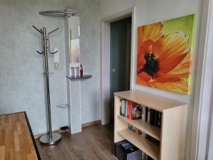 a living room with a sunflower painting on the wall at Exklusivwohnung Bad Dürrenberg in Bad Dürrenberg