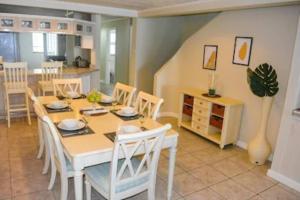 a kitchen and dining room with a table and chairs at The Bliss in Gros Islet