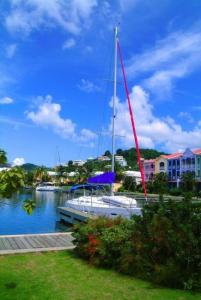 a sailboat docked at a dock in a harbor at The Bliss in Gros Islet