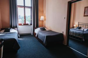 Posteľ alebo postele v izbe v ubytovaní Hotel Centrum