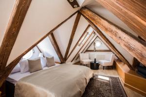 a bedroom with a bed in a attic at Hotel Nerudova 211 in Prague